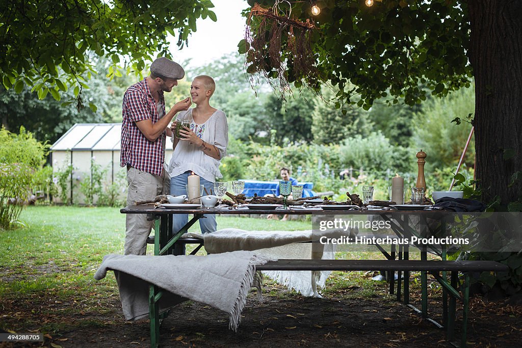 Couple standing at table for garden party