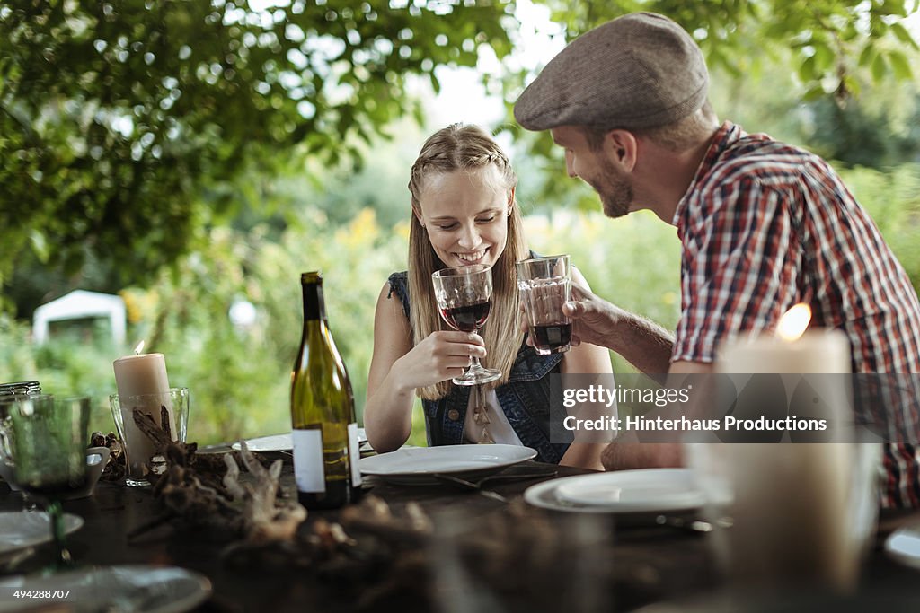 Couple Drinking Wine At Garden Party
