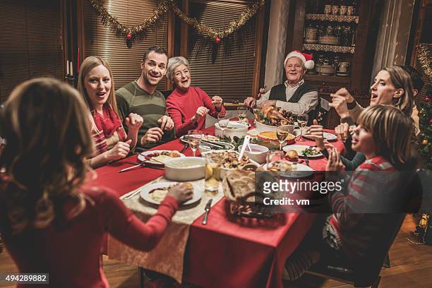 large family celebrating christmas holiday - white dinner stockfoto's en -beelden