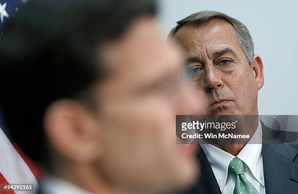 Speaker of the House John Boehner listens as House Majority Leader Eric Cantor answers questions during a press conference following a meeting of the...