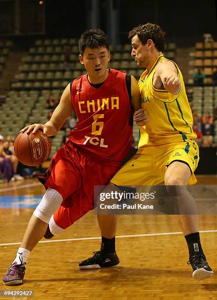 Quan Gu of China drives to the basket against Ben Madgen of Australia during the 2014 Sino-Australia Challenge match between Australia and China at...