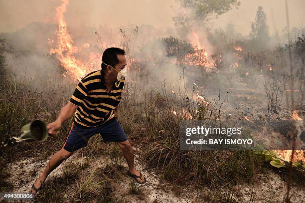 Villager tries to extinguish a peatland fire on the outskirts of Palangkaraya city, Central Kalimantan on October 26, 2015. For nearly two months,...