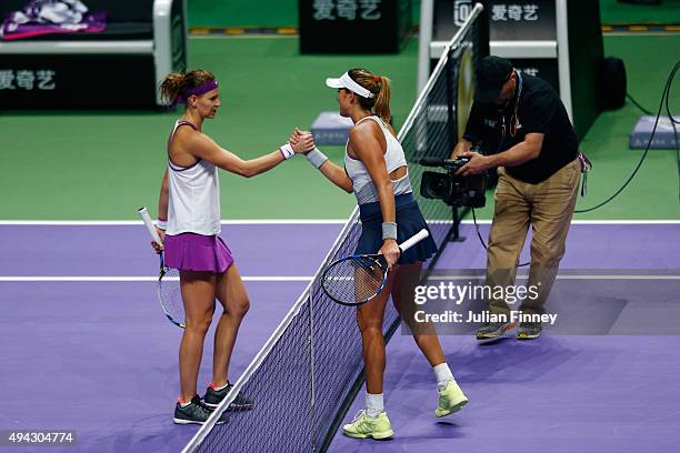 Garbine Muguruza of Spain shakes hands with Lucie Safarova of Czech Republic after defeating her in a round robin match during the BNP Paribas WTA...