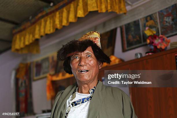 Tashi Tsering poses for a portrait in traditional Khampa dress at his home in the Paljor Ling Refugee Camp on May 18, 2014 in Pokhara, Nepal. Tsering...