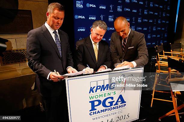 Mike Whan, Commissioner, LPGA Tour, John Veihmeyer, Chairman, KPMG, and Pete Bevacqua, CEO, PGA of America sign the final contract for the KPMG...