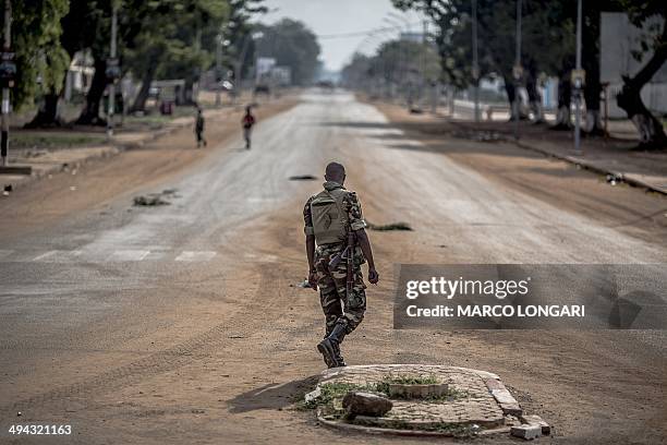 Soldier of the African-led International Support Mission to the Central African Republic crosses the main avenue at the Lakengua district of Bangui...