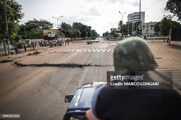 Member of the Central African republic National Gendarmerie patrols on his truck in an avenue at the Lakengua district of Bangui on May 29, 2014. At...
