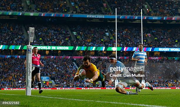 Adam Ashley-Cooper of Australia dives over to scores his sides second try despite the tackle by Pablo Matera of Argentina during the 2015 Rugby World...