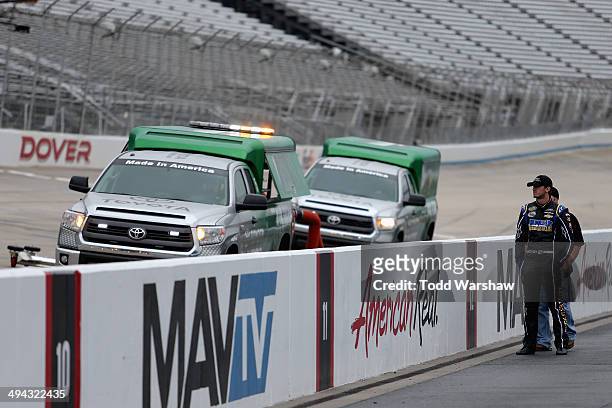Ben Kennedy, driver of the Click It Or Ticket Chevrolet, watches from pit road as Air-Titan 2.0 track dryers run prior to practice for the NASCAR...