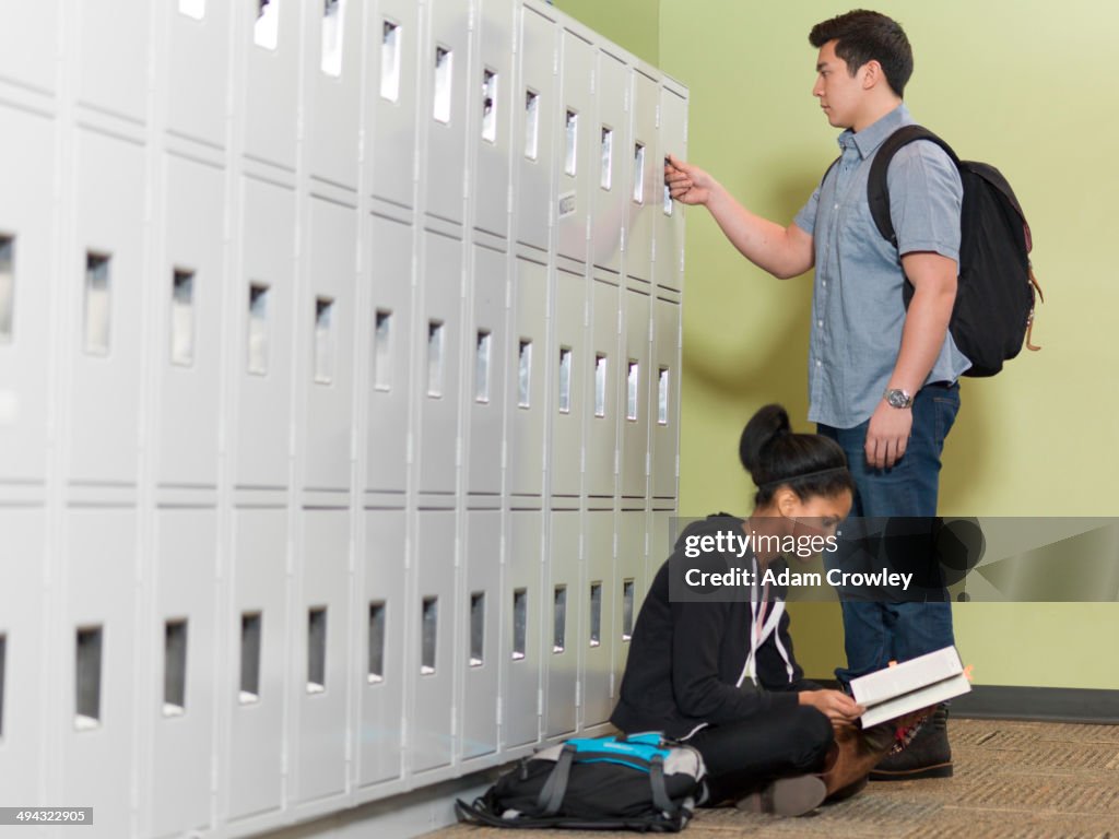 Students by lockers in school corridor