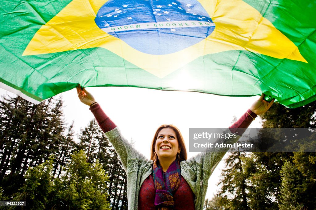 Hispanic woman flying Brazilian flag