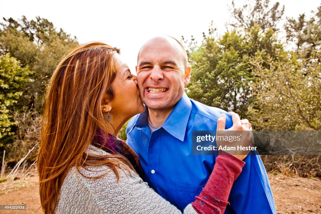 Hispanic couple kissing in park