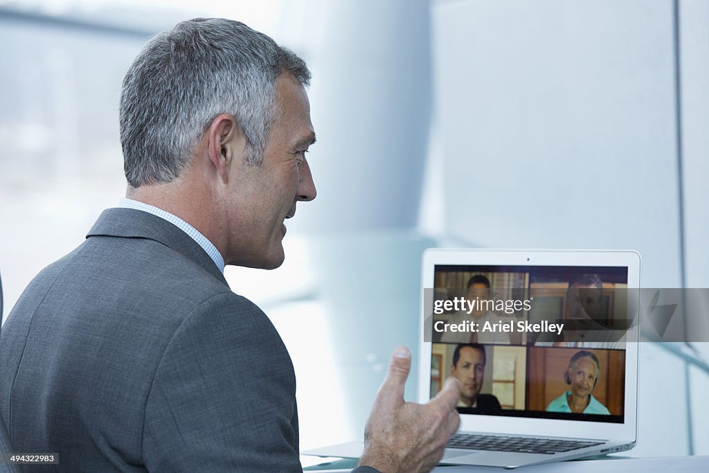 Businessman having teleconference on laptop in office