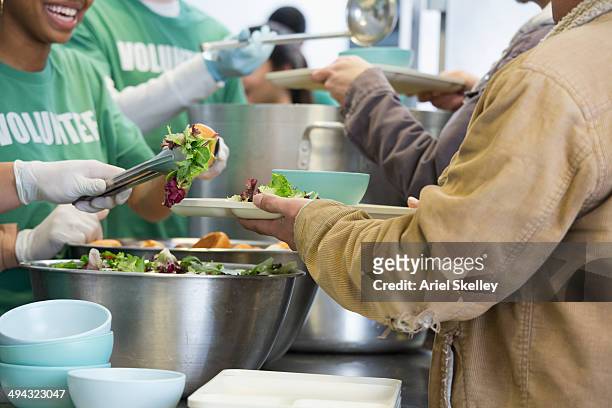 volunteers working in soup kitchen - soup kitchen stock pictures, royalty-free photos & images