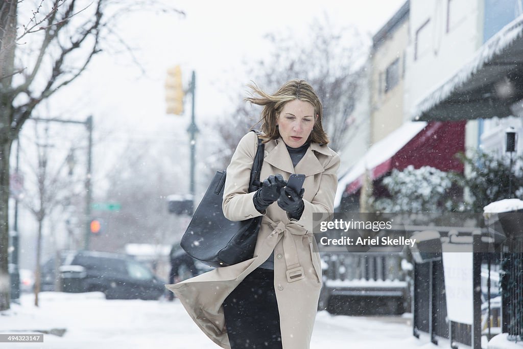 Woman walking on snowy street