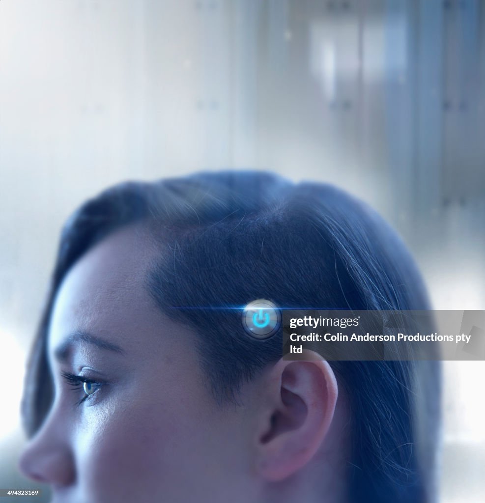 Mixed race woman with power button on head