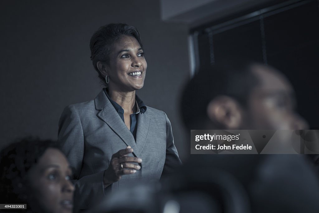 Business people watching audio visual presentation in meeting