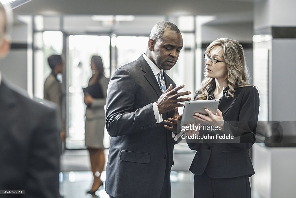 Business people using digital tablet in office