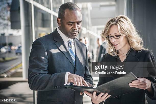 business people talking outside office building - man check suit stock pictures, royalty-free photos & images