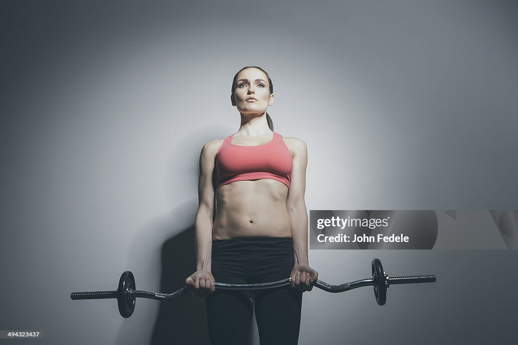 Caucasian woman holding barbell