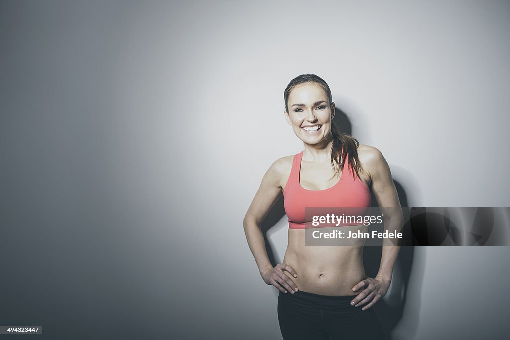 Portrait of smiling Caucasian woman in sports-bra