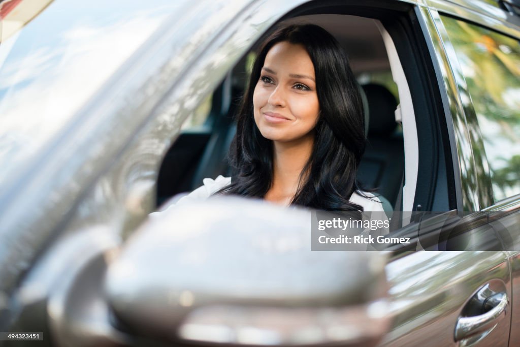 Hispanic woman driving car