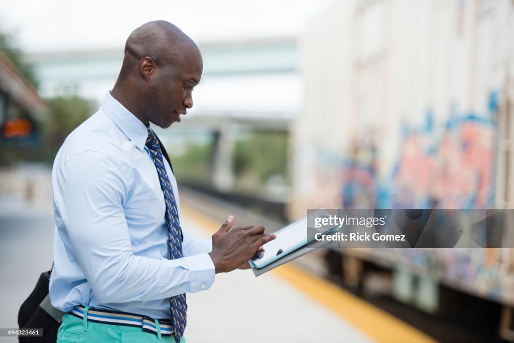 African American businessman waiting for train