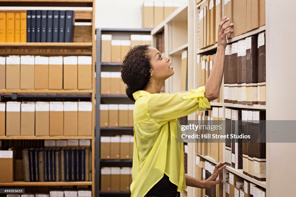 Mixed race student working in library