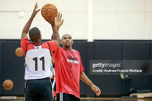 Toronto Raptors' assistant coach Jerry Stackhouse works with guard Shannon Scott at practice.