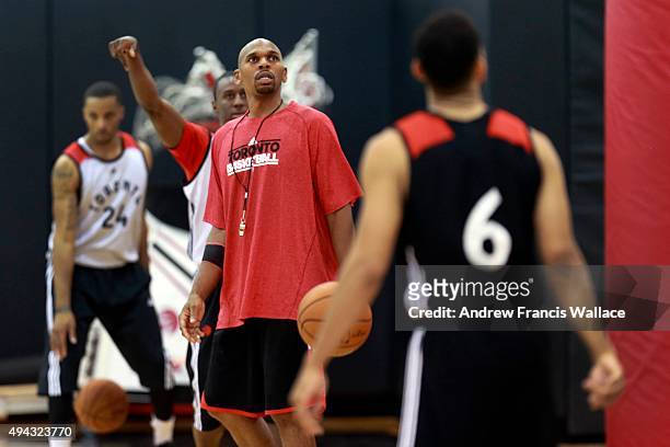 Toronto Raptors' assistant coach Jerry Stackhouse works with guard Shannon Scott at practice.