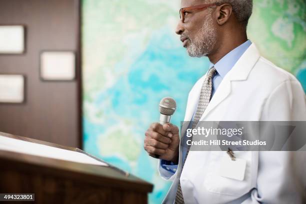 black doctor giving presentation - black man giving speech stock pictures, royalty-free photos & images