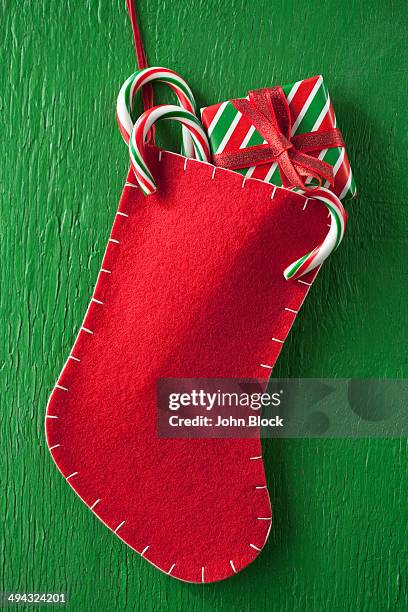 christmas stocking with gift and candy canes - stocking stock pictures, royalty-free photos & images