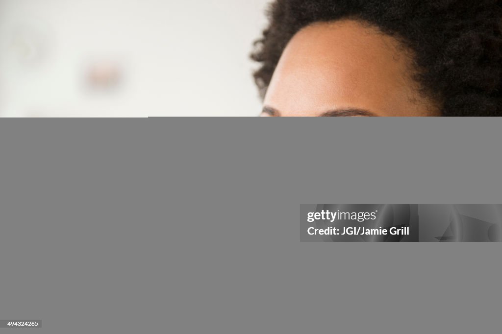 Close up of Black woman smiling with fingers crossed