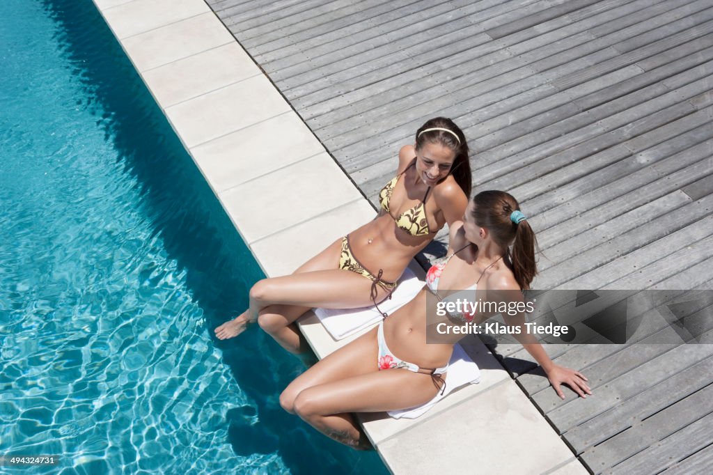 Caucasian women relaxing by swimming pool