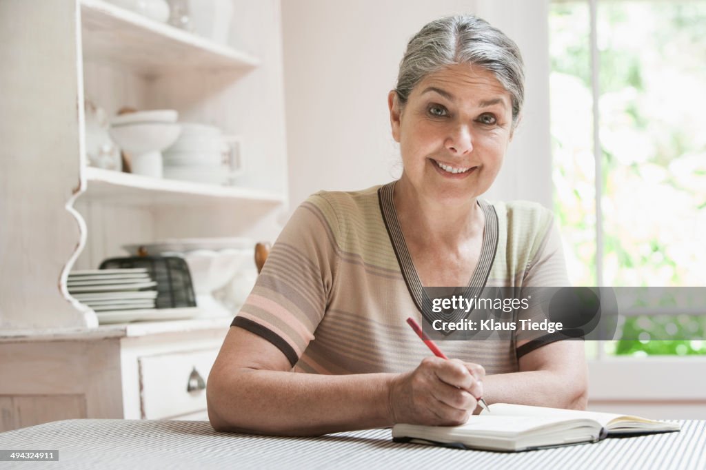 Caucasian woman writing in journal