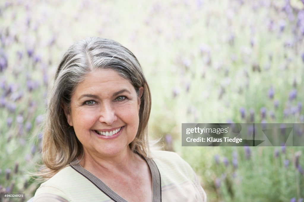 Caucasian woman smiling in lavender field