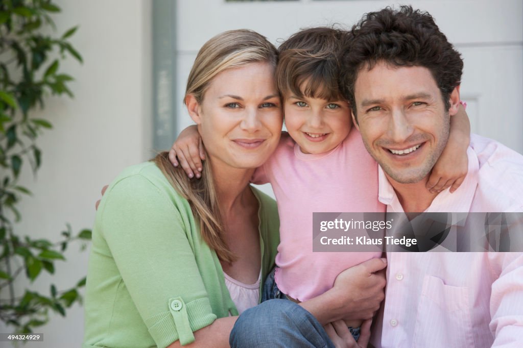 Caucasian family smiling outdoors