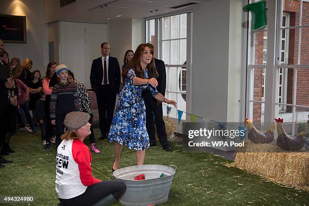 Catherine, Duchess of Cambridge takes part in welly wanging, watched by the Prince William, Duke of Cambridge with children and representatives from...