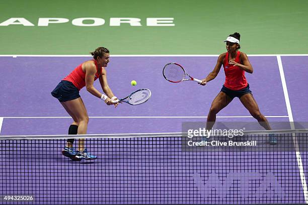 Abigail Spears and Raquel Kops-Jones of the USA in action against Sania Mirza of India and Martina Hingis of Switzerland during the BNP Paribas WTA...