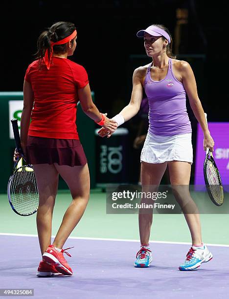 Sania Mirza of India and Martina Hingis of Switzerland in action against Raquel Kops-Jones and Abigail Spears of the USA during the BNP Paribas WTA...