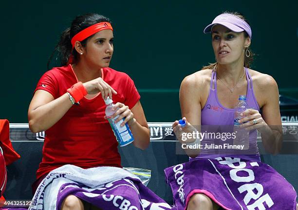 Sania Mirza of India and Martina Hingis of Switzerlandtake a break during their round robin match against Raquel Kops-Jones and Abigail Spears of the...