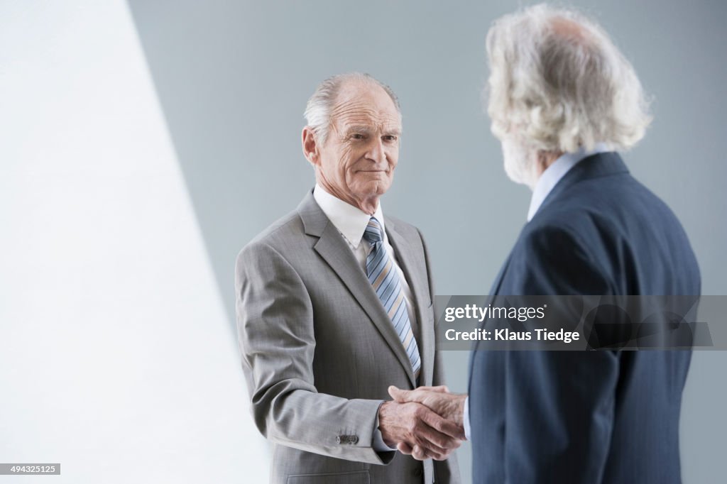 Senior Caucasian businessmen shaking hands