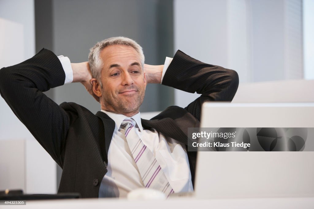 Businessman relaxing at desk in office