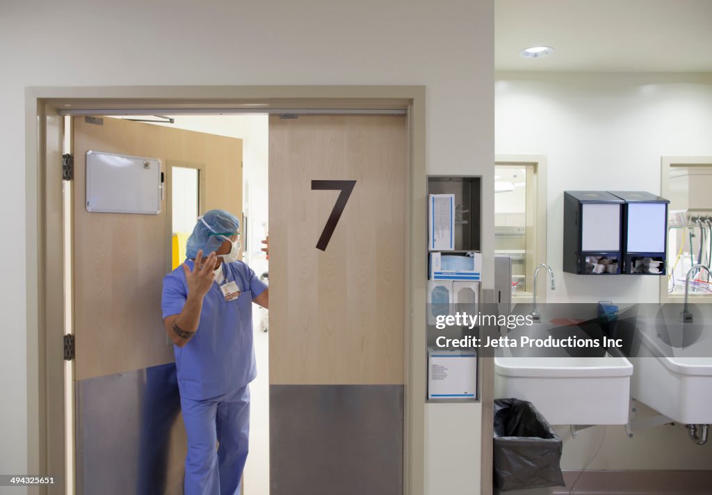 Pacific Islander surgeon leaving operating room