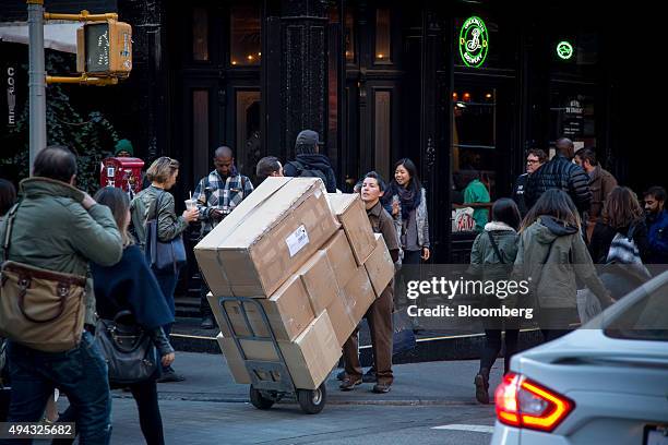 United Parcel Service Inc. Driver picks up packages from businesses in the Soho neighborhood of New York, U.S., on Friday, Oct. 23, 2015. UPS is...