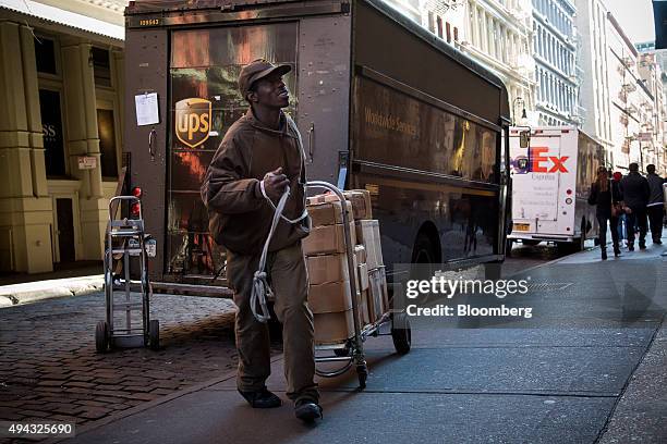 United Parcel Service Inc. Driver delivers packages in New York, U.S., on Friday, Oct. 23, 2015. UPS is scheduled to release third-quarter earnings...