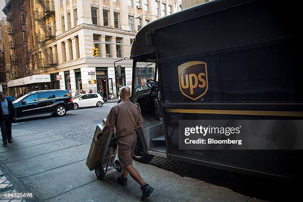 United Parcel Service Inc. Driver delivers packages in New York, U.S., on Friday, Oct. 23, 2015. UPS is scheduled to release third-quarter earnings...