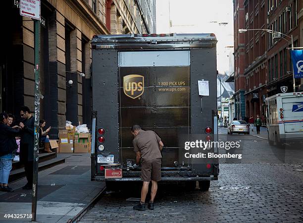 United Parcel Service Inc. Driver opens a truck parked in New York, U.S., on Friday, Oct. 23, 2015. UPS is scheduled to release third-quarter...