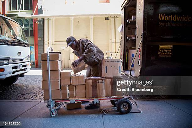 United Parcel Service Inc. Driver loads a cart with boxes in New York, U.S., on Friday, Oct. 23, 2015. UPS is scheduled to release third-quarter...