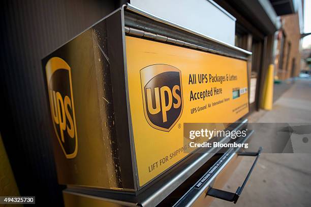 The United Parcel Service Inc. Logo is displayed on a drop box in New York, U.S., on Friday, Oct. 23, 2015. UPS is scheduled to release third-quarter...
